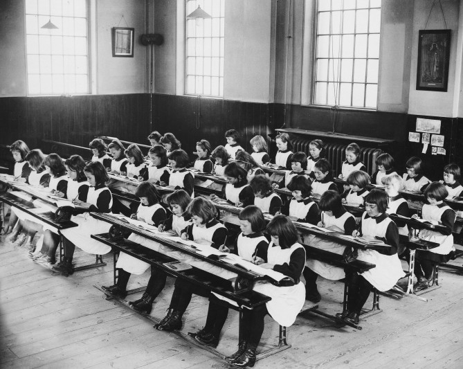 Girls in the London Foundling Hospital schoolroom, 20th century. 