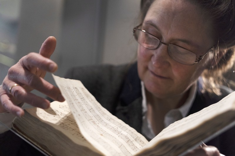 Curator viewing the manuscript.